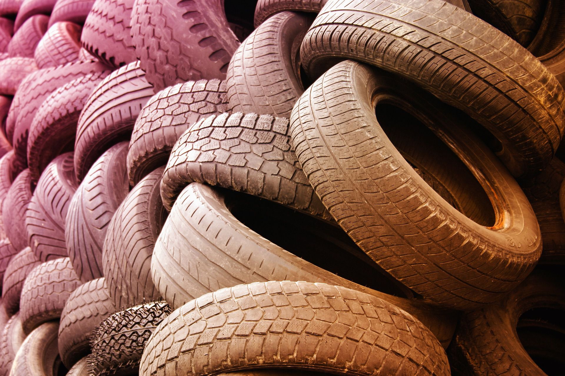 a large pile of used car tyres